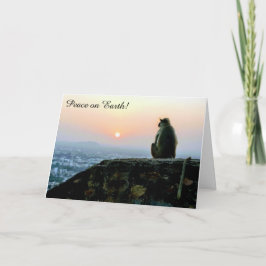 Fred på jorden apa vid solnedgång högtids kort