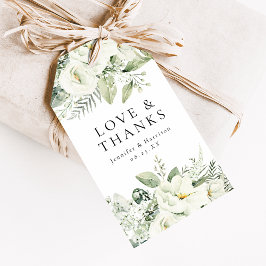 Frodiga vita blommor och grönska som bröllopsgåva presentetikett