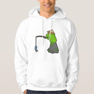 Frog på sten vid fiske med fiskstav och fisk hoodie