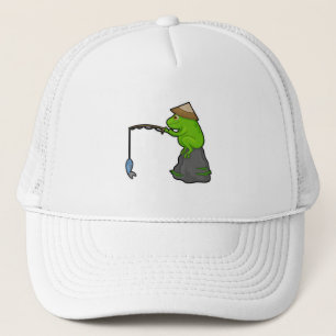 Frog på sten vid fiske med fiskstav och fisk keps