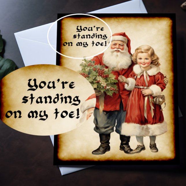 Funny jultomten kort (A Victorian Christmas card with humorous picture on the front is lying on top of a desk.)