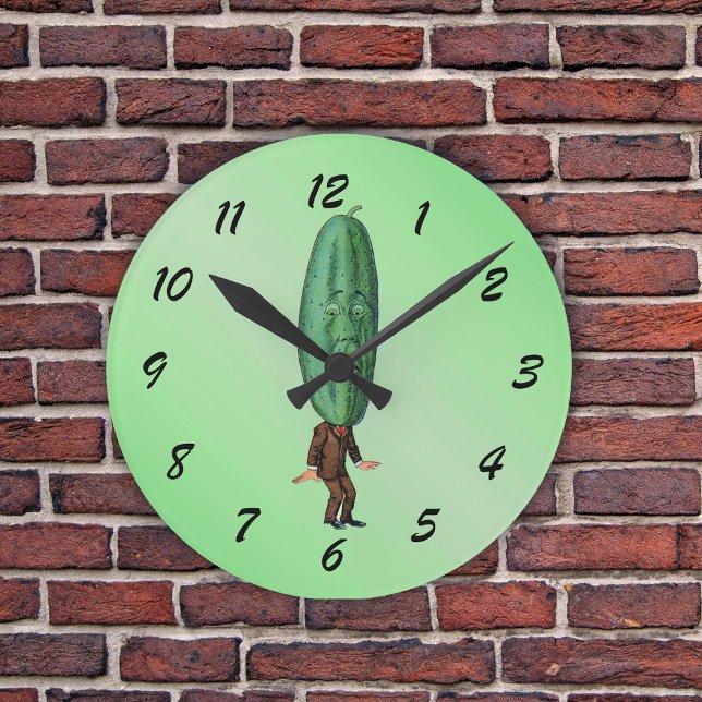 Funny Pickle Head Man Wearing Kostym Rund Klocka (Fun man in suit with big green pickle head with a face on a light green round wall clock.)
