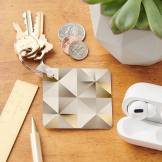 Geometric relief texture in beige and gold nyckelring