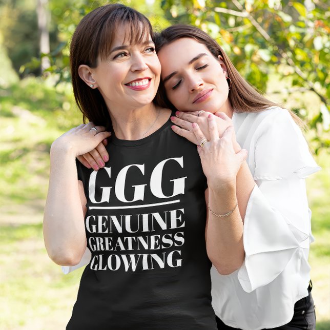 GG- Äkta, storhet, glödande T Shirt (A daughter holds her mother. The mother wears a "GGG: Genuine, Greatness Glowing" black t-shirt.)