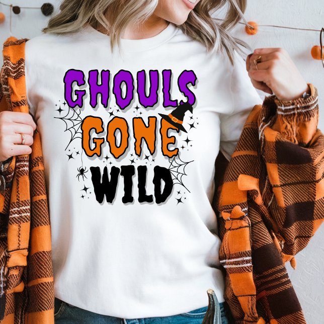 Ghouls Borta Vild Modern Halloween T Shirt (Women in a white sweater with Girls Gone Wild topography an orange plaid top for Halloween.)