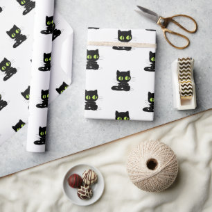 Glänsande presentpapper svart katt gröna ögon