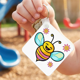 Glatt leende kawaii bebiböna med söta blommor nyckelring
