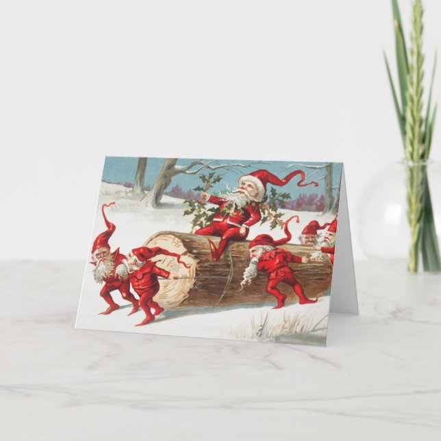 Gnomes dragging a cut tree trunk through the snow kort (Framsida)