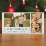 God jul 3 Photo Elegant Botanical Julkort<br><div class="desc">Skicka tidlösa semesterhälsningar med det här grönten för elegantens -julkort. 8×4-panoramabildens layout innehåller tre fotopunkter, ett klassiskt "God jul"-meddelande i mjuk elfenbenstext och subtila botaniska sprickor för en förfinad, modern beröring. Kortets baksida fortsätter att se ut med ett känsligt grönt mönster som skapar en polerad avsluta. Perfekt för familjer tittar...</div>