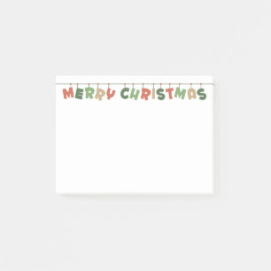 God jul färgad text som hänger på trädgårdsmark post-it block