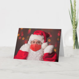 God jul Jultomten som sätter på Ansikte Mask Helgkort