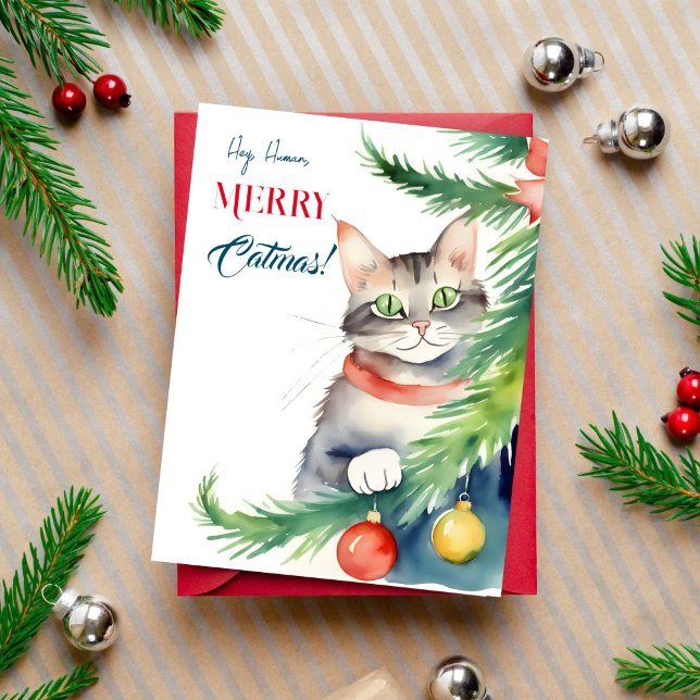 God jul på kattmänniskor vykort (Merry catmas Christmas greeting postcard for cat people cute green eyed cat peeping by  tree)