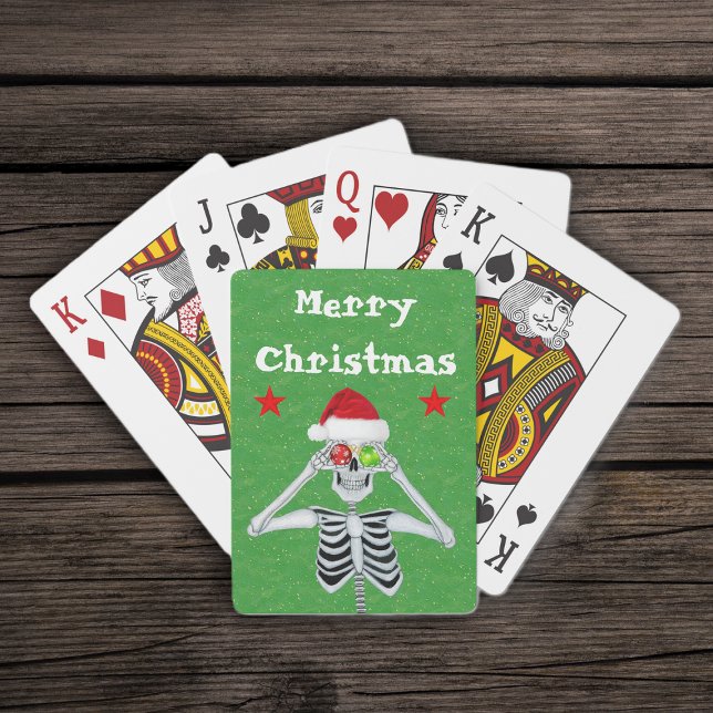 God jul Skeleton Ornaments Stars Santa Hat Casinokort (Merry Christmas silly skeleton ornament eyes  red stars on green deck of playing cards.)