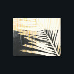 Golden Raffia - Handflatan Fronds Canvastryck<br><div class="desc">Golden Raffia II av Jennifer Paxton Parker. Har en enda löv-silhuett från handflatan i svart och gult/tan färg.</div>