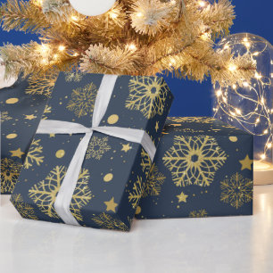 Golden snöflingor på marinemballering pappert presentpapper