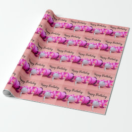Golf boll med rosa polka prickband på rosa presentpapper