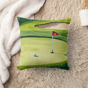 Golf boll och flagga på grönt kudde