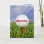 Golf Boll on Tee for Grandson Kort<br><div class="desc">Stäng golf boll på rödborgen i grönt gräs för morsons födelsedag. Text på boll kan redigeras.</div>