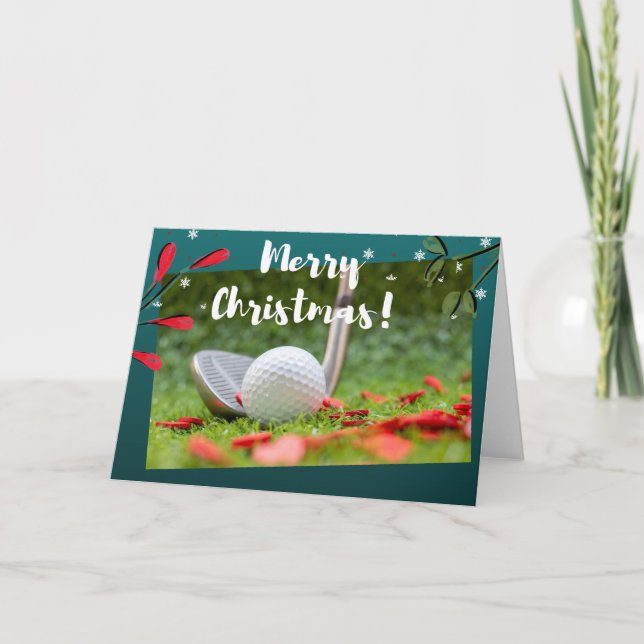 Golf järn och boll är på grönt jul kort (Framsida)