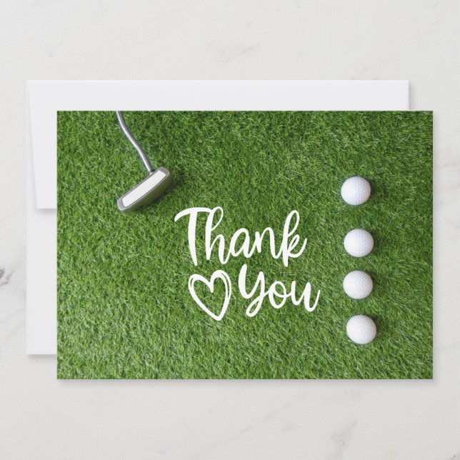 Golf putter  are on green grass Thank you Tack Kort (Framsida)