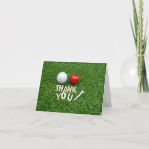 Golf-tack med äpple och golf boll på grönt tack kort
