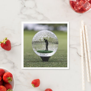 Golfboll i glas med golfspelare inuti, pappersservett