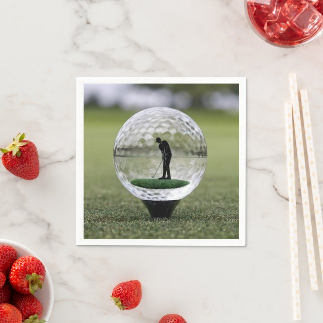Golfboll i glas med golfspelare inuti, pappersservett (Insitu)