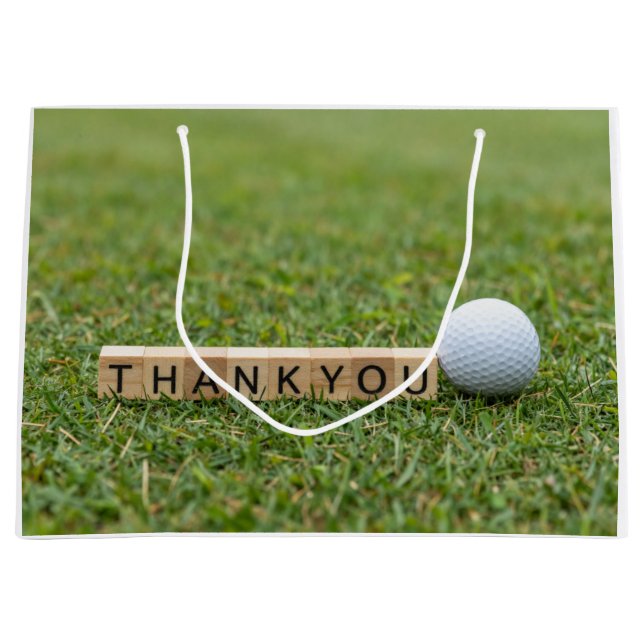 Golfboll med texten Tack på grön gräsmatta (Framsidan)