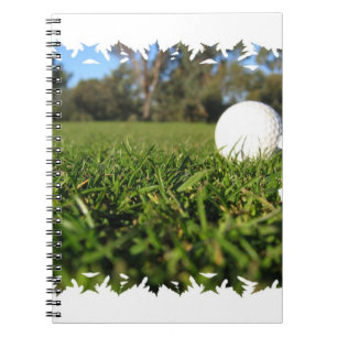 Golfbollen jagar på anteckningsboken anteckningsbok