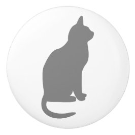 Grå sittande katt vänd åt höger knopp