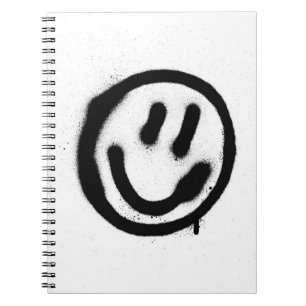 Graffiti leende ansikte-emoticon i svart på whites anteckningsbok