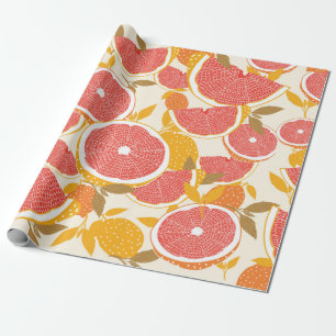 Grapefrukt och halverade segment med löv på vitt. presentpapper