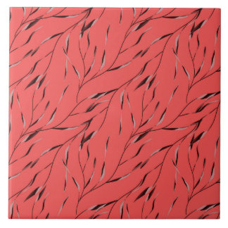 Grenar med blad på en röd bakgrund. kakelplatta