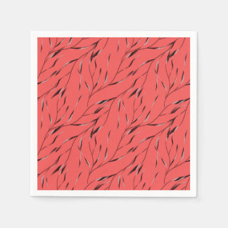 Grenar med blad på en röd bakgrund. pappersservett