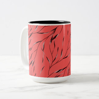 Grenar med blad på en röd bakgrund. Två-Tonad mugg