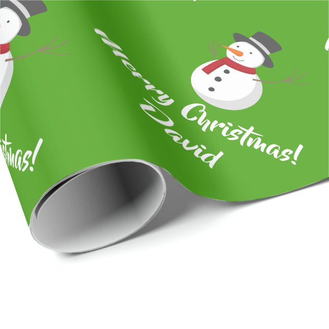 Grön god julsnögubbe som slår in papper presentpapper (Rullad Hörn)