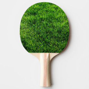 Grön grässtruktur från ett fotbollfält pingisracket