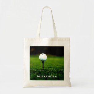 Grön grästorva och golfboll/utslagsplats, tygkasse