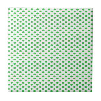 Grön polka dots på vit kakelplatta