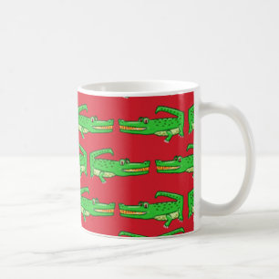 Gröna krokodiler på rött kaffemugg