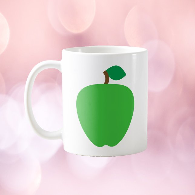 Grönt äppelfrukt kaffemugg (A mug with a graphic of a green apple.)