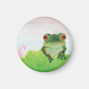 Grönt Frog bakom den lila plattans magnet