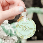 Grönten Mint för Guld Frills Mint i maid of honor  Nyckelring<br><div class="desc">Dessa nyckelkedjor är designade för ge som Maid of honor i er bröllopsfest. De har en enkel utformning av eleganten med blek mint grönt färgad bakgrund, guld-text och en lacy golden faux foil blommigt gräns. Texten lyder "Maid of honor" med plats för hennes namn, parets namn och bröllop-datumet. Perfekt för...</div>