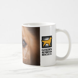 GRRNT-ansikte av en guld- mugg