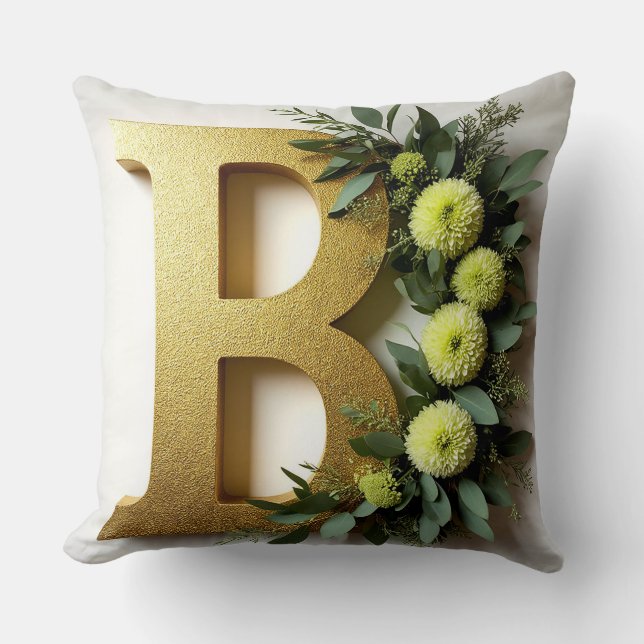 Gul bokstav B omgiven av blomsterarrangemang Kudde (Framsida)