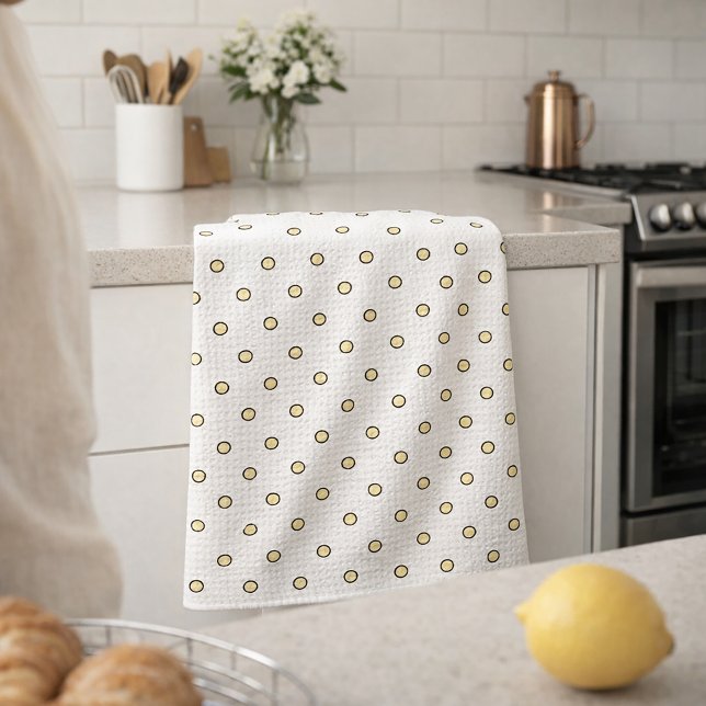 Gul och svart cirkelmönster kökshandduk (A kitchen towel with a pattern of yellow and black dots)