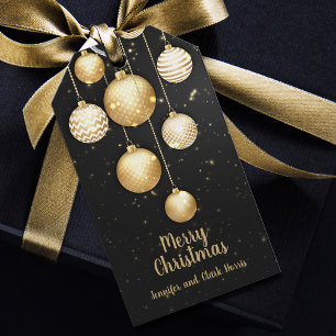Guld Baubles-julprydnader på Black Favor Presentetikett
