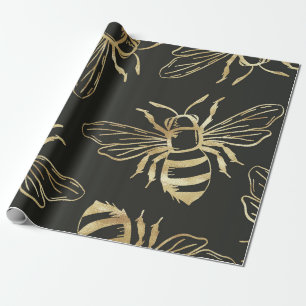Guld Bee Design, i svart bakgrund. Presentpapper