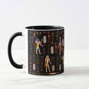 Guld-egyptiska hieroglyfer och gudom på svart mugg