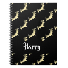 Guld fladdermöss på svart anteckningsbok